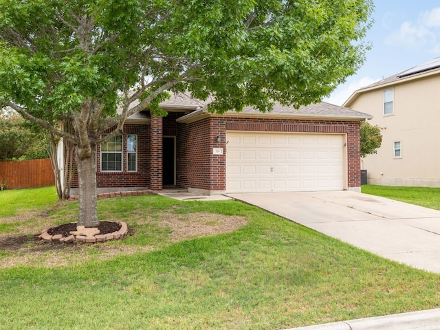 116 Brown St, Hutto, TX 78634 - obstructed view of property featuring a garage, driveway, and brick siding