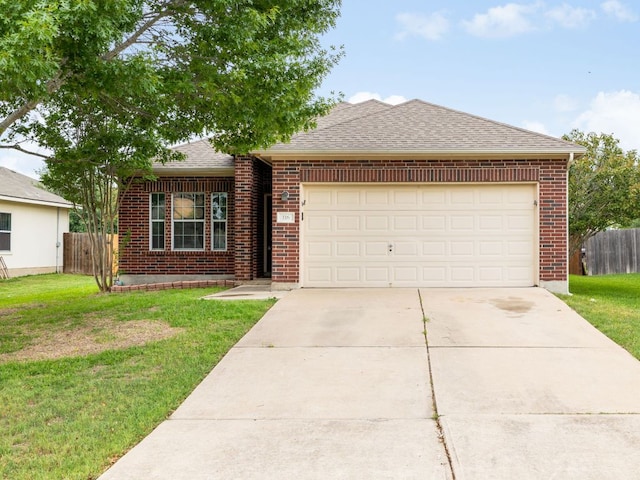 116 Brown St, Hutto, TX 78634 - view of front facade featuring concrete driveway, a garage, brick siding, and a shingled roof