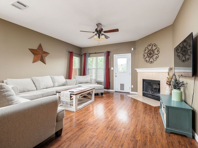 116 Brown St, Hutto, TX 78634 - living room with ceiling fan, a tile fireplace, wood finished floors, and baseboards