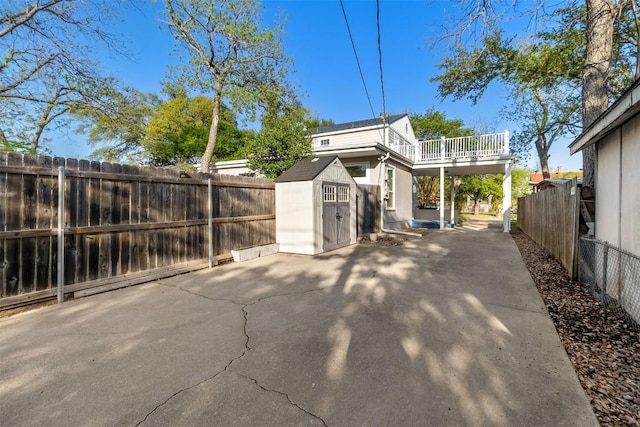 1308 N 13th St, Temple, TX 76501 - view of property exterior featuring a fenced backyard, an outbuilding, a patio area, and a storage unit