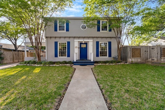 1308 N 13th St, Temple, TX 76501 - colonial inspired home with a gate, a front lawn, fence, and stucco siding