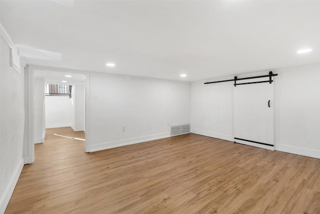 1308 N 13th St, Temple, TX 76501 - basement featuring a barn door, light wood-style floors, baseboards, visible vents, and recessed lighting
