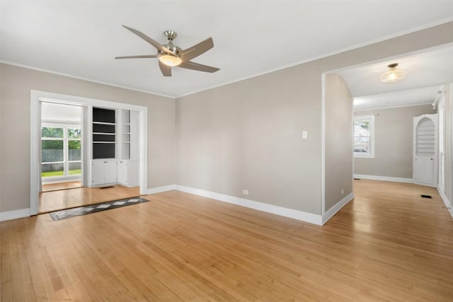 1308 N 13th St, Temple, TX 76501 - empty room featuring ornamental molding, a ceiling fan, light wood-style floors, and plenty of natural light