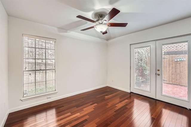 unfurnished room with a wealth of natural light, dark wood-style floors, and french doors