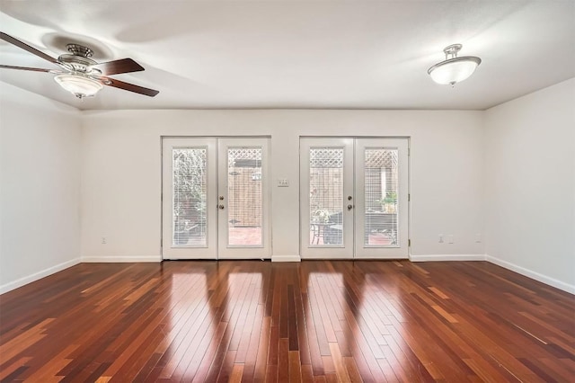 empty room featuring hardwood / wood-style flooring, baseboards, and french doors