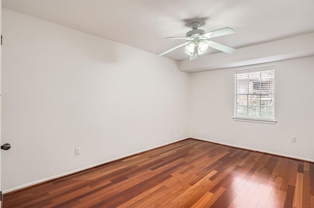 unfurnished room featuring wood finished floors, a ceiling fan, and baseboards