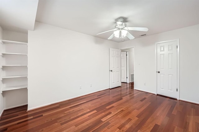 unfurnished bedroom featuring visible vents, baseboards, a ceiling fan, and wood finished floors