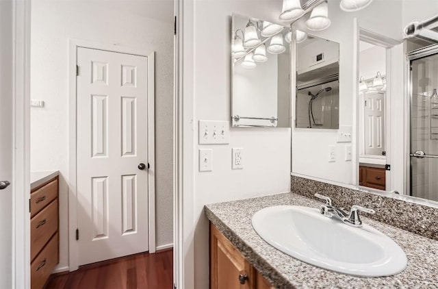 bathroom with wood finished floors, visible vents, and vanity