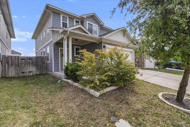 view of front of property featuring an attached garage, driveway, a front yard, and fence
