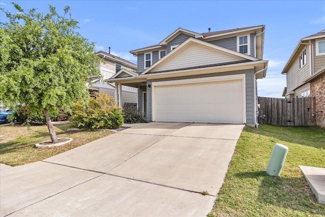 traditional-style home with fence, an attached garage, a front lawn, and concrete driveway