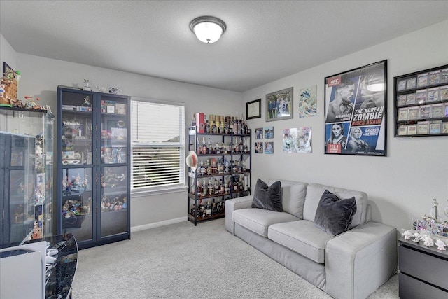 carpeted living area with baseboards