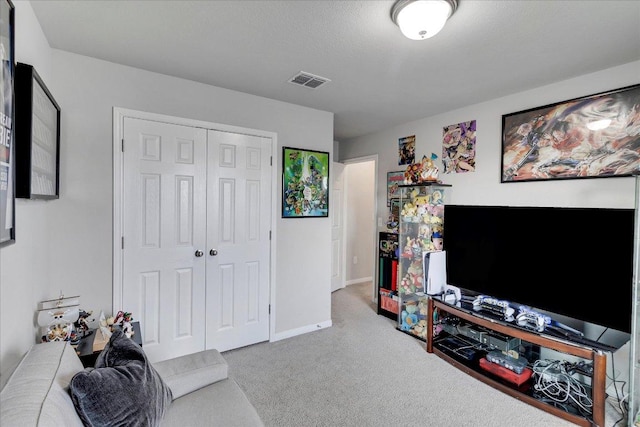 carpeted living area with baseboards and visible vents