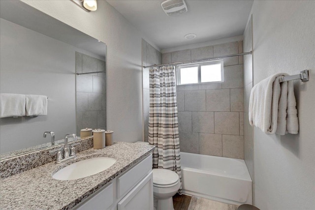 full bathroom featuring toilet, visible vents, shower / bath combo with shower curtain, wood finished floors, and vanity