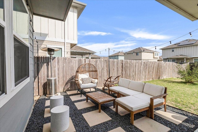 view of patio / terrace featuring a fenced backyard, an outdoor living space, and a residential view