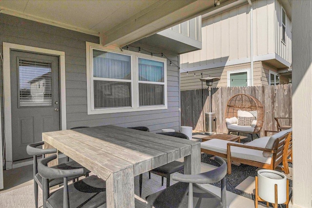 view of patio with fence and outdoor dining space