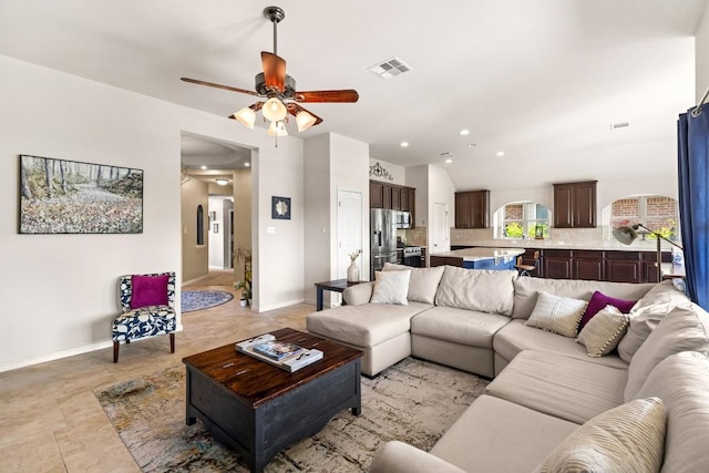 living room featuring vaulted ceiling, baseboards, visible vents, recessed lighting, and ceiling fan