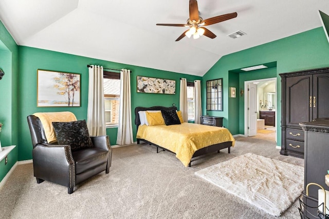 bedroom with vaulted ceiling, baseboards, and light colored carpet