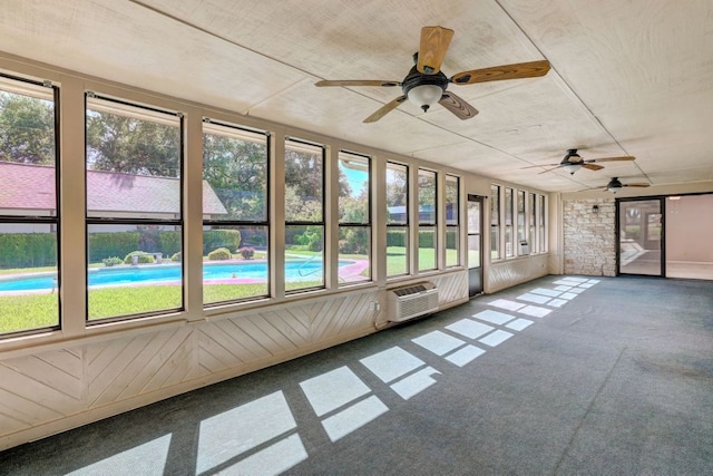 unfurnished sunroom with a wealth of natural light and a ceiling fan