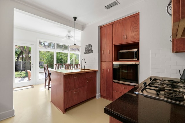 4103 Ave F, Austin, TX 78751 - kitchen with wall oven, stainless steel microwave, tasteful backsplash, a sink, and ornamental molding