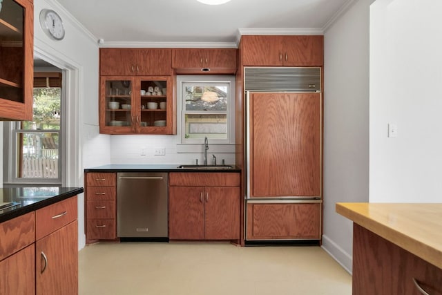 4103 Ave F, Austin, TX 78751 - kitchen with paneled fridge, stainless steel dishwasher, a sink, crown molding, and glass insert cabinets