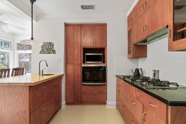 4103 Ave F, Austin, TX 78751 - kitchen featuring appliances with stainless steel finishes, a sink, tasteful backsplash, a peninsula, and exhaust hood