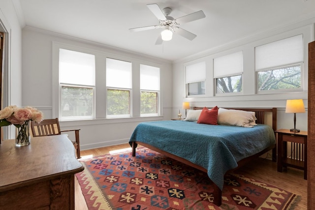 4103 Ave F, Austin, TX 78751 - bedroom featuring wood finished floors, ornamental molding, baseboards, and a ceiling fan