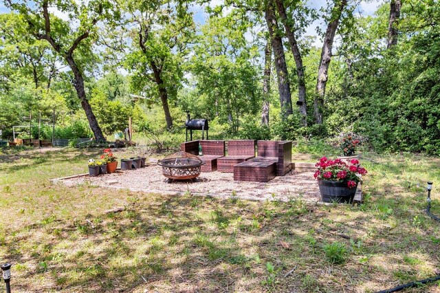 view of yard featuring an outdoor fire pit