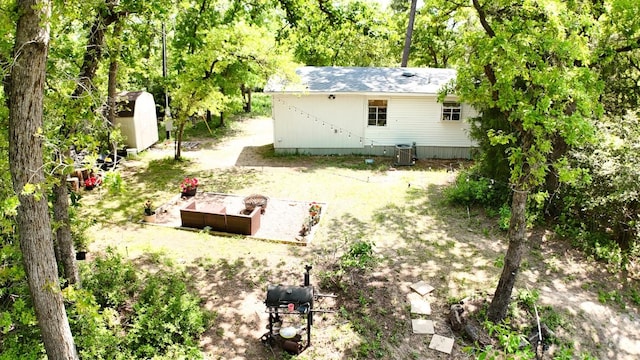 rear view of house with an outdoor structure and a shed