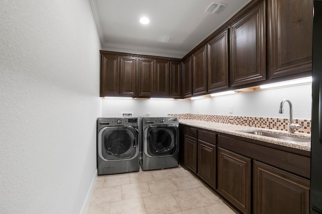 2304 High Lonesome, Leander, TX 78641 - washroom featuring cabinet space, washer and dryer, ornamental molding, baseboards, and light tile patterned floors