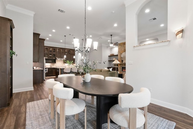 2304 High Lonesome, Leander, TX 78641 - dining room with baseboards, crown molding, dark wood-style flooring, a ceiling fan, and recessed lighting
