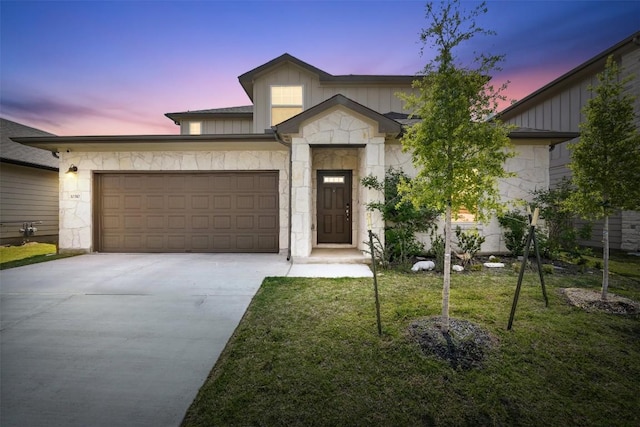 10310 Mager Ln, Hutto, TX 78634 - view of front facade featuring stone siding, driveway, a garage, and board and batten siding