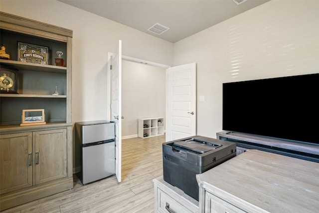 10310 Mager Ln, Hutto, TX 78634 - kitchen featuring freestanding refrigerator, light wood finished floors, and light countertops