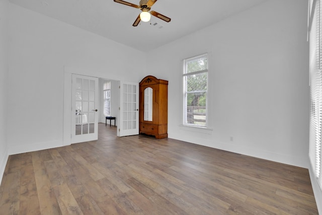 interior space featuring baseboards, french doors, visible vents, and wood-type flooring