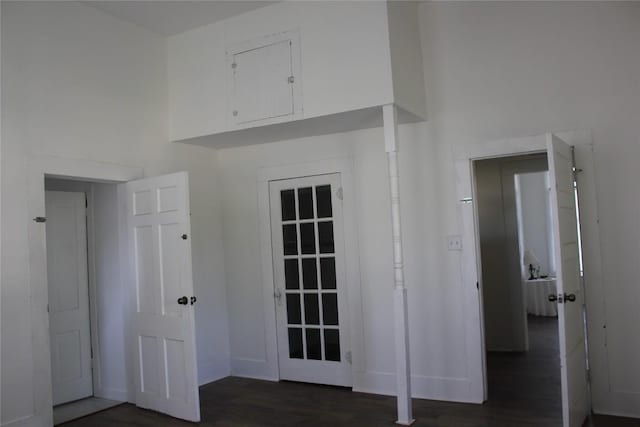 interior space featuring baseboards and dark wood-style flooring