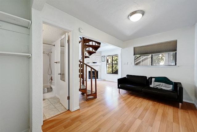 2500 Burleson Rd Unit 311, Austin, TX 78741 - corridor featuring wood finished floors, stairway, and baseboards