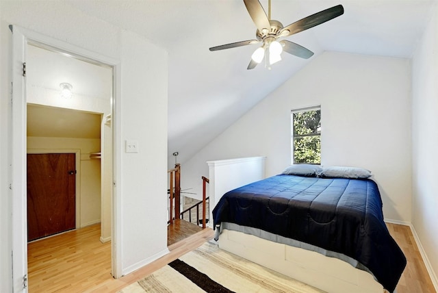 2500 Burleson Rd Unit 311, Austin, TX 78741 - bedroom featuring wood finished floors, vaulted ceiling, baseboards, and ceiling fan