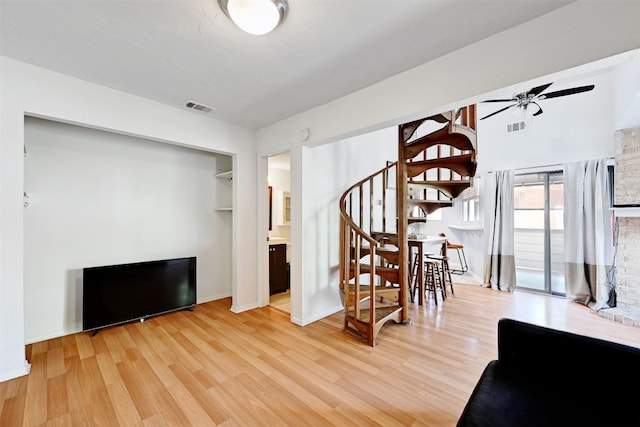 2500 Burleson Rd Unit 311, Austin, TX 78741 - living area with ceiling fan, wood finished floors, stairs, and baseboards
