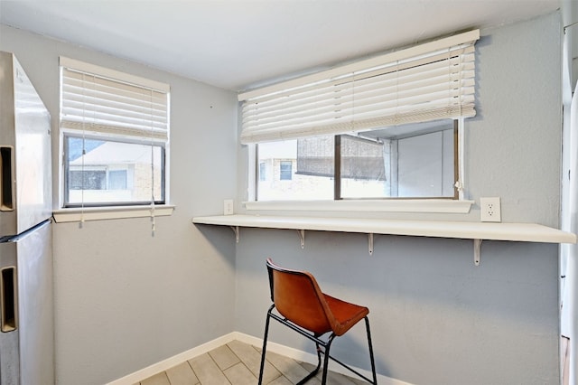 2500 Burleson Rd Unit 311, Austin, TX 78741 - unfurnished dining area with baseboards and wood finished floors