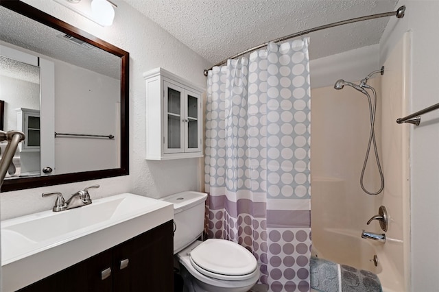 2500 Burleson Rd Unit 311, Austin, TX 78741 - bathroom with a textured ceiling, toilet, a textured wall, vanity, and shower / bath combo with shower curtain