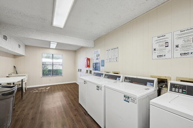 2500 Burleson Rd Unit 311, Austin, TX 78741 - community laundry with dark wood-style flooring, washing machine and dryer, a textured ceiling, and baseboards