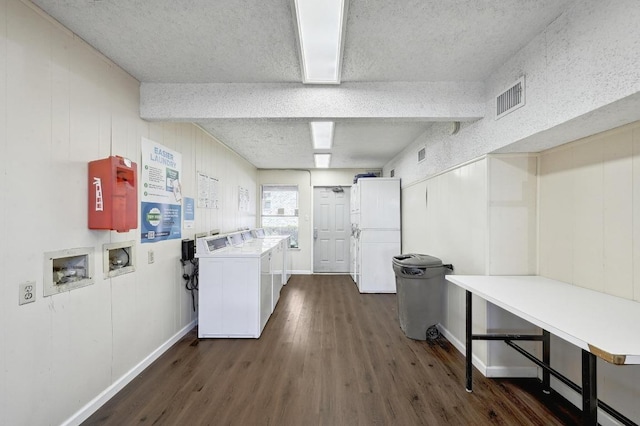 2500 Burleson Rd Unit 311, Austin, TX 78741 - community laundry room with dark wood-type flooring, baseboards, and a textured ceiling