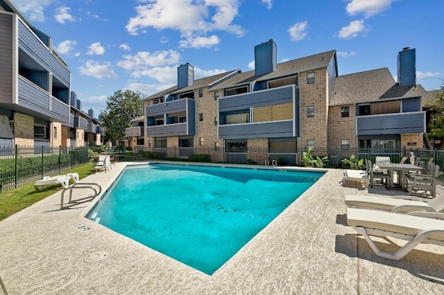 2500 Burleson Rd Unit 311, Austin, TX 78741 - community pool with fence, a residential view, and a patio
