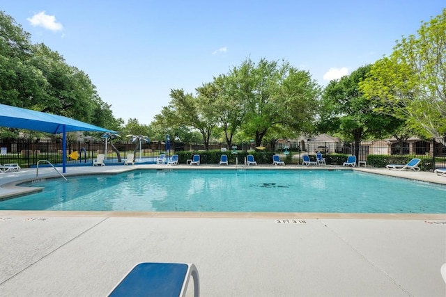community pool featuring fence and a patio area