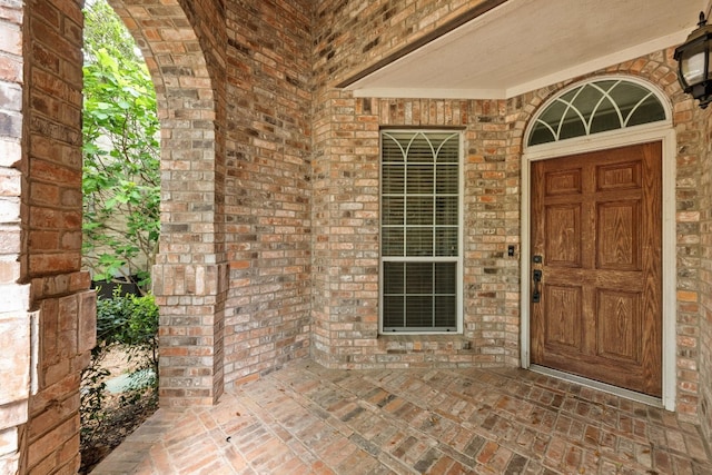 entrance to property with brick siding