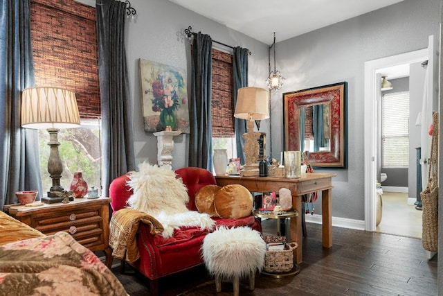living area featuring baseboards and wood finished floors