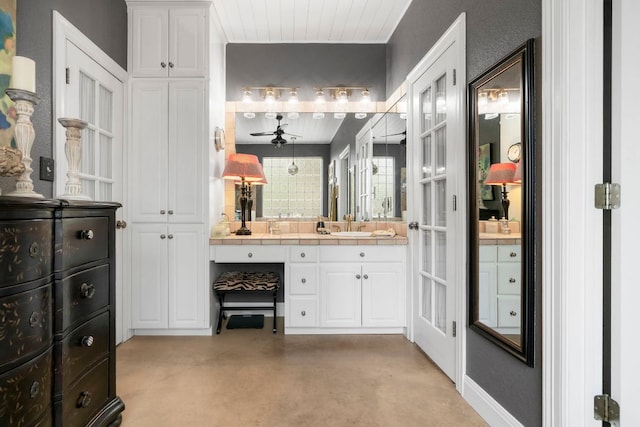 bathroom featuring finished concrete flooring, vanity, and a ceiling fan