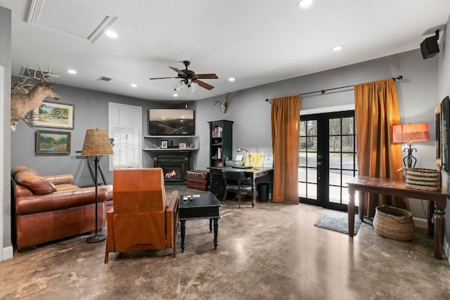 living area with recessed lighting, a ceiling fan, french doors, a lit fireplace, and finished concrete floors