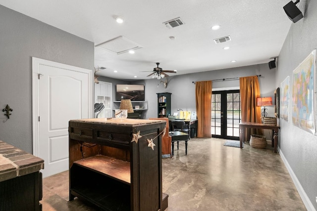 interior space featuring a textured wall, french doors, visible vents, and finished concrete flooring