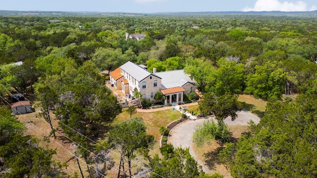 drone / aerial view featuring a view of trees