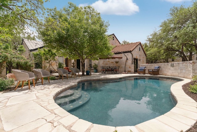 view of swimming pool featuring fence, a patio area, and a fenced in pool